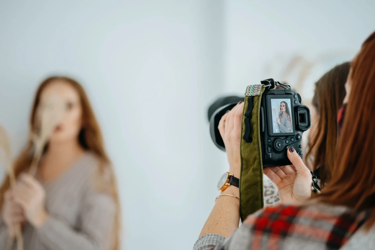 Young photographer holding a professional camera